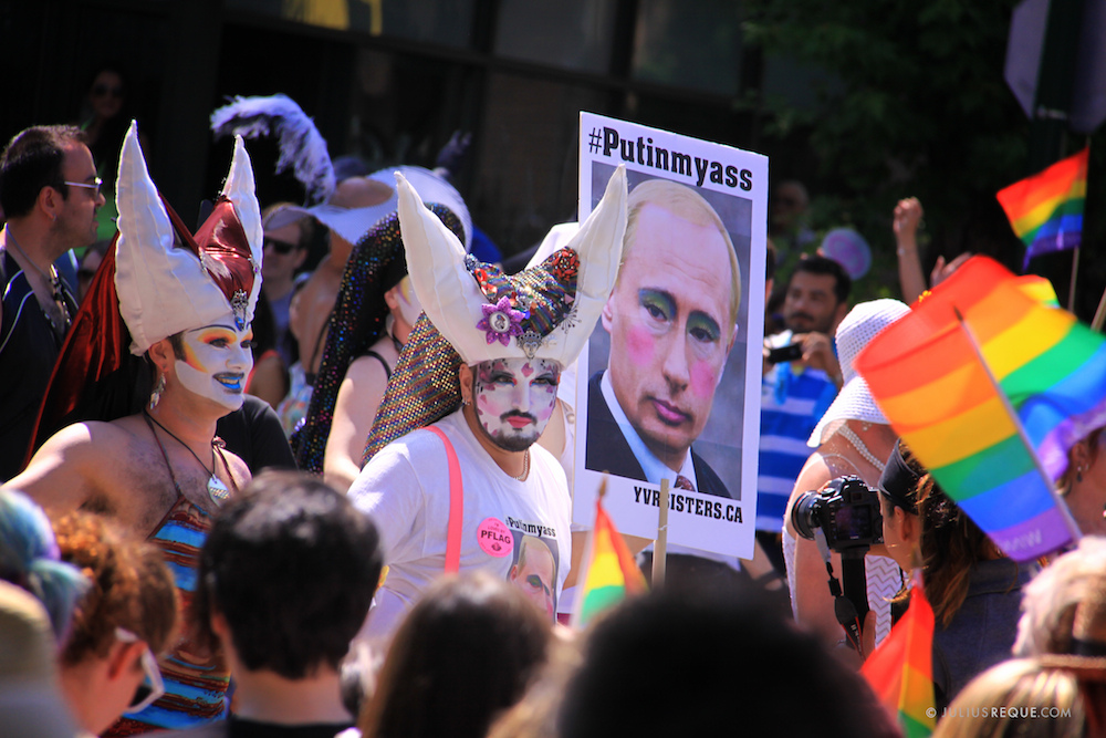 4 August 2013, Canada. Vancouver Gay Pride Parade participants hold signs protesting Vladimir Putin’s stance on LGBT rights in Russia.