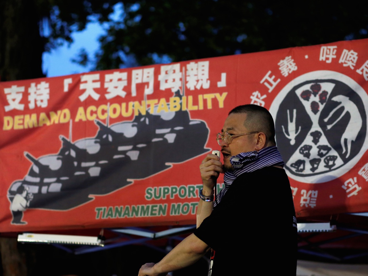 On 4 June 2016, an activist in Hong Kong urges people to join a candlelight vigil to mark the 27th anniversary of the crackdown on a pro-democracy movement at Beijing's Tiananmen Square in 1989