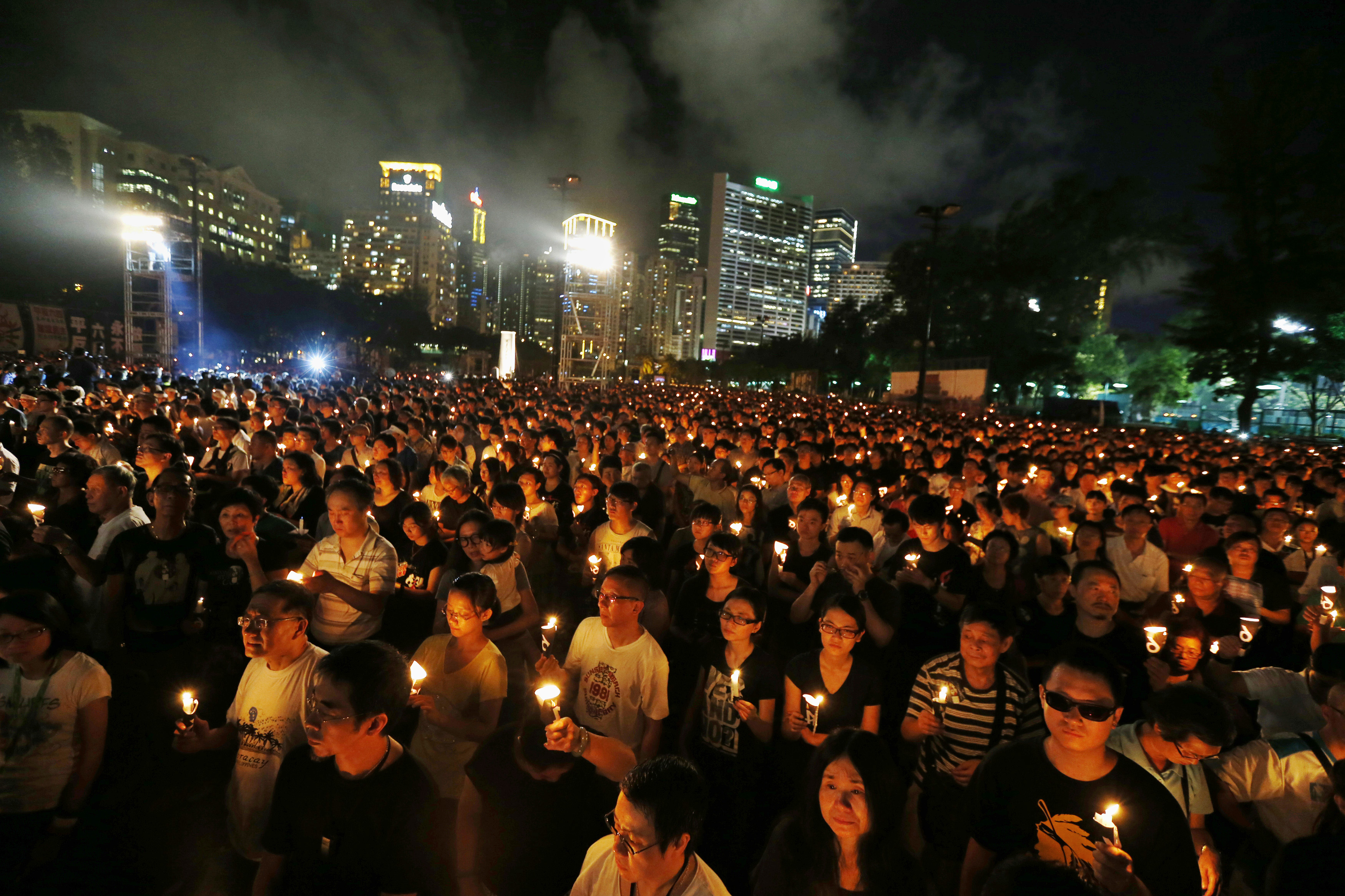 Tens of thousands of people take part in a candlelight vigil at Hong Kong's Victoria Park on 4 June 2014, to mark the 25th anniversary of the military crackdown in Beijing