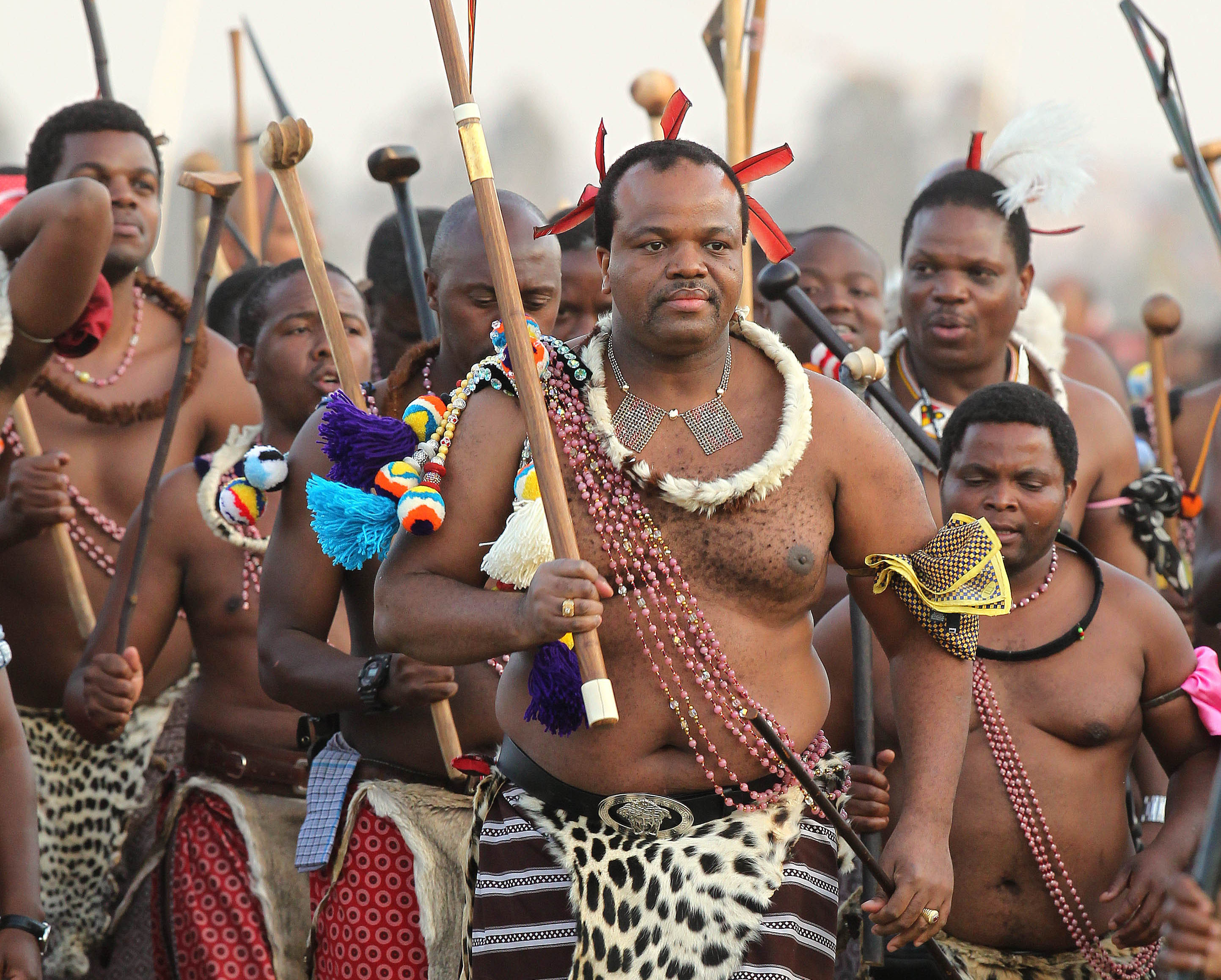 King Mswati III, front, dances during a Reed Dance in Mbabane, Swaziland, September 2012.