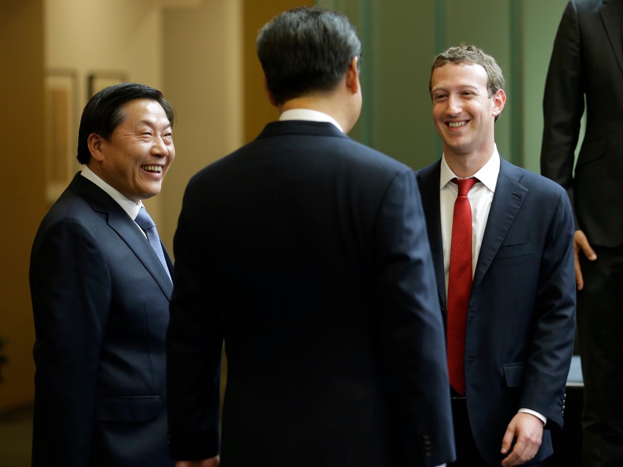 In this 23 Sept. 2015 file photo, Chinese President Xi Jinping, center, talks with Facebook Chief Executive Mark Zuckerberg, right, as Lu Wei, left, China's Internet czar, looks on during a gathering of CEOs and other executives at Microsoft's main campus in Redmond, Washington