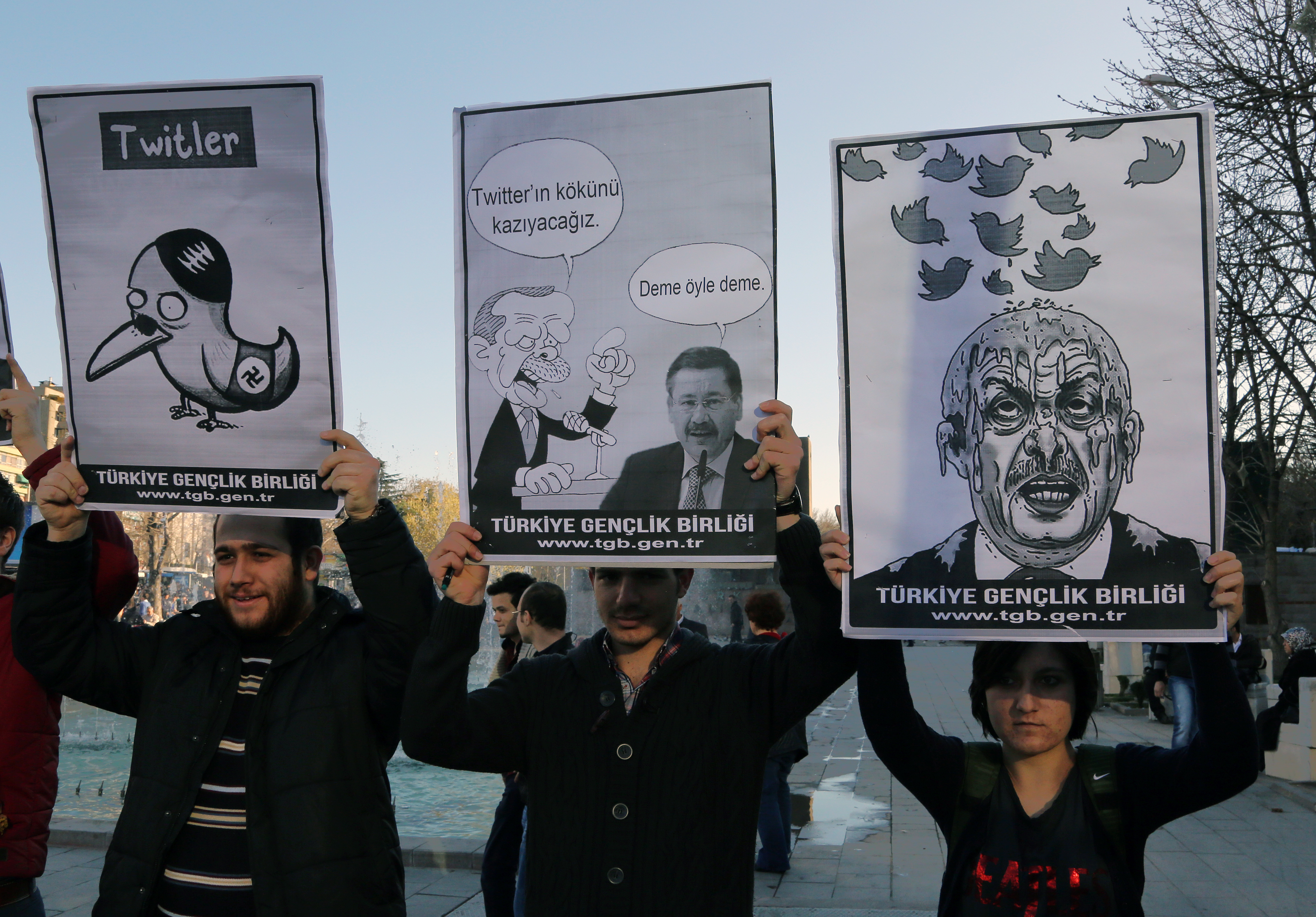 Members of the Turkish Youth Union hold cartoons depicting Turkey's Prime Minister Recep Tayyip Erdogan during a protest against a ban on Twitter, in Ankara, 21 March 2014.